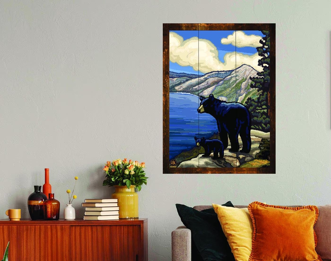 Living room with a bear painting on the wall, wooden sideboard, and gray sofa.